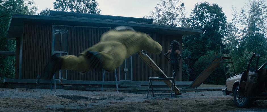 Juggernaut dives after Domino as she runs past the playground.