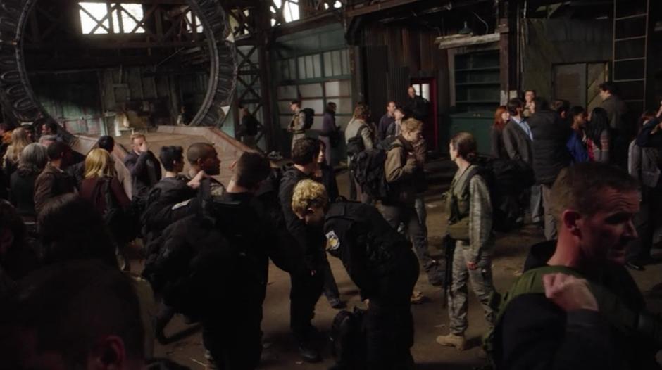The crew of the Destiny stands near the stargate.