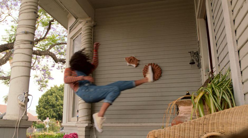 Molly flies through the air after being thrown through the front door.