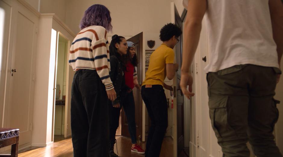 Alex opens the door to the hidden stairs while Gert, Nico, Molly, and Chase wait.