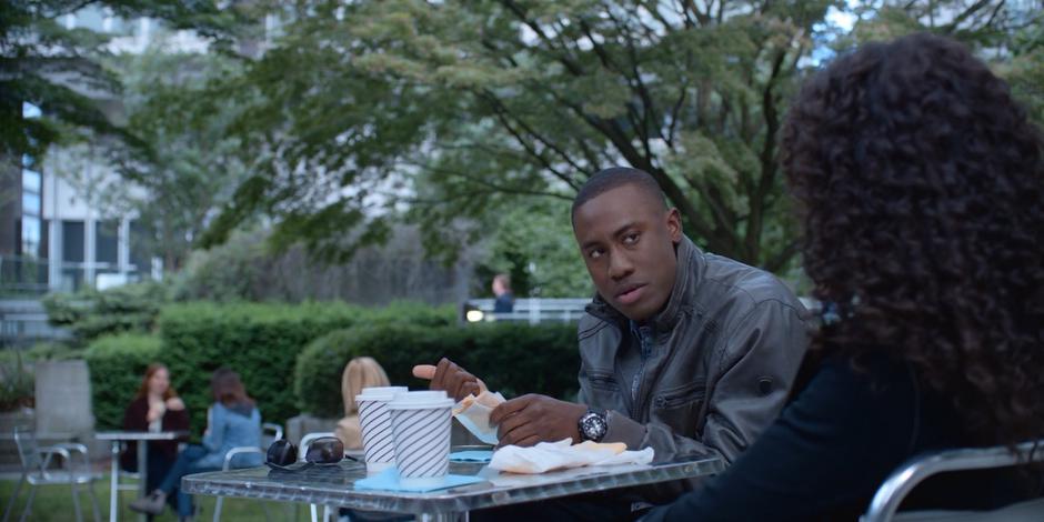 Jeff looks over at Carly as he is eating his food.