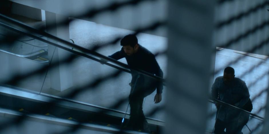 Jack and Jeff walk up the deactivated escalator to the second floor.