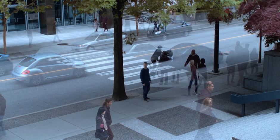 Philip looks around at all of the ghostly people and cars from other timelines.