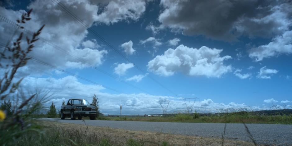 Andrew Graham drives his car down the road beneath some power lines.