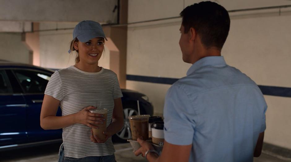 Karolina asks for Vaughn's help getting into Jonah's office while holding one of the iced coffees for him.
