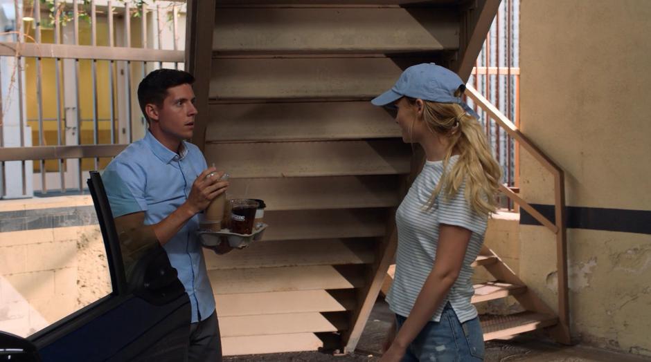 Karolina talks to Vaughn as he is getting out of his car with a tray full of coffees.