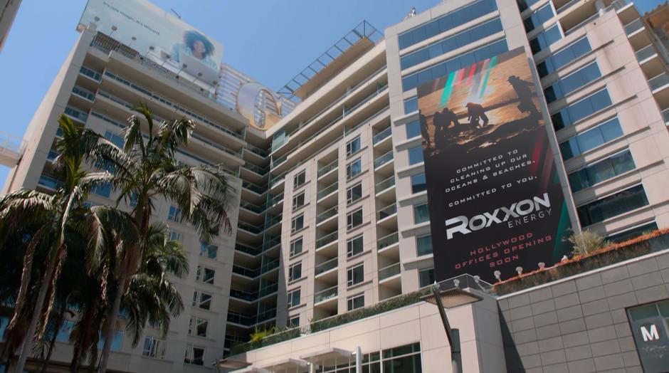 Establishing shot of the hotel with a giant Roxxon Energy advertisement.