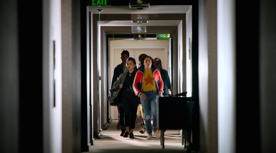 Nico and Molly lead the others down the hallway.