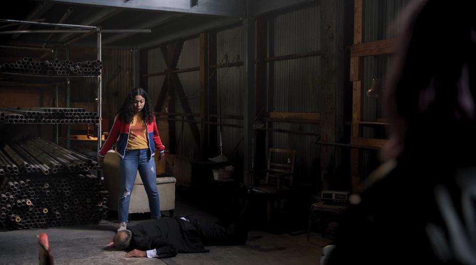 Molly drops Detective Flores to the ground as her friends watch.