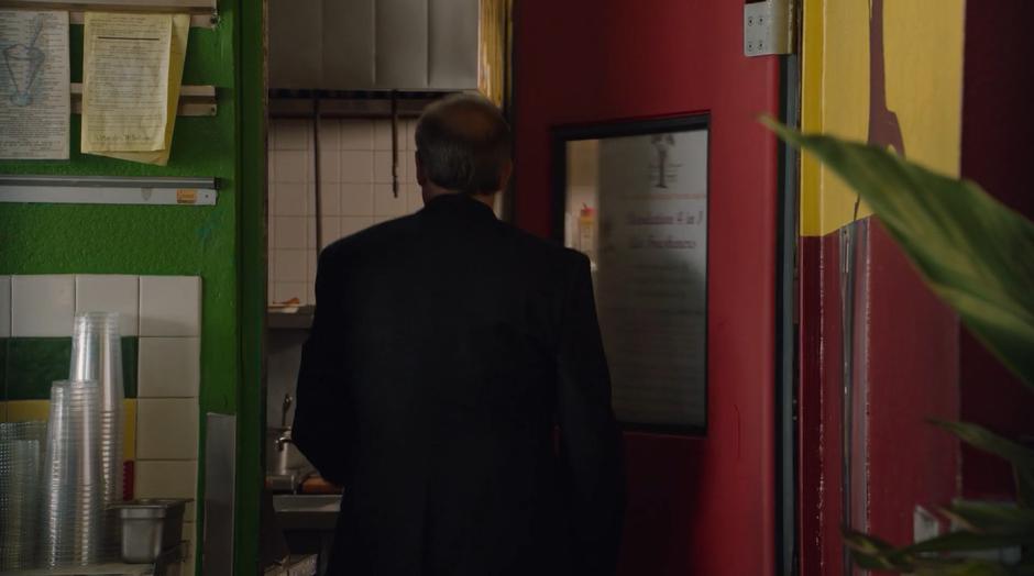 Detective Flores goes into the back of the restaurant looking for AWOL.