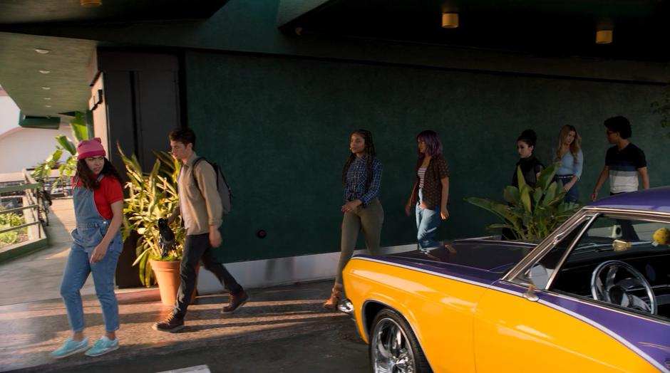 Molly, Chase, Livvie, Gert, Nico, Karolina, and Alex walk out to their car.