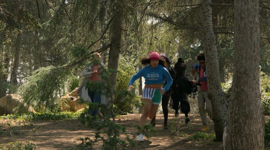 Karolina, Molly, Gert, Nico, and Alex run through forest chased by the drones.