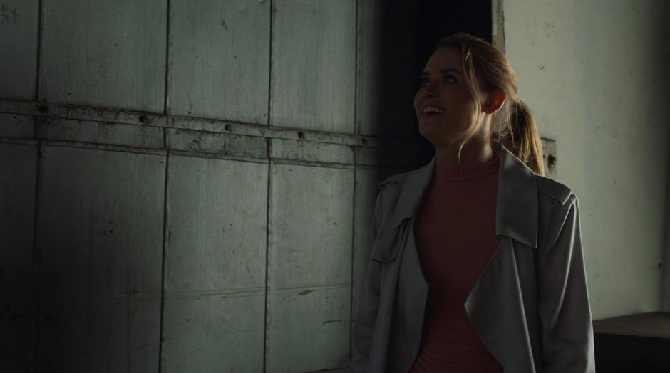 Karolina smiles after closing the door to lock out the drone following her.