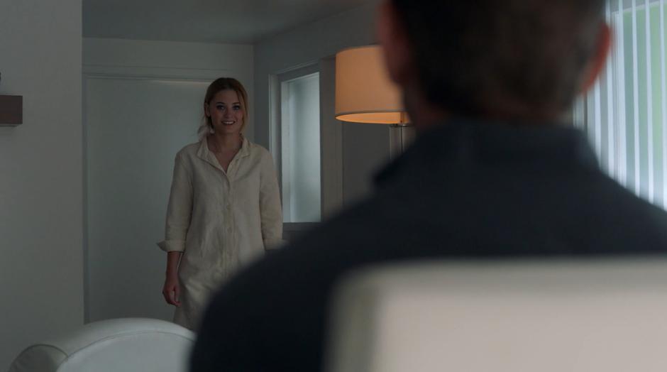 Karolina smiles while entering the office to talk to her father.