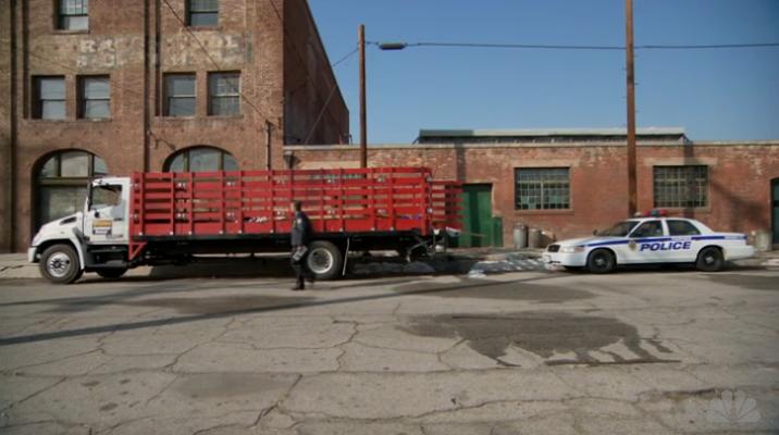 Ron Swanson's rental truck is parked on the side of the street after the police pulled him over.