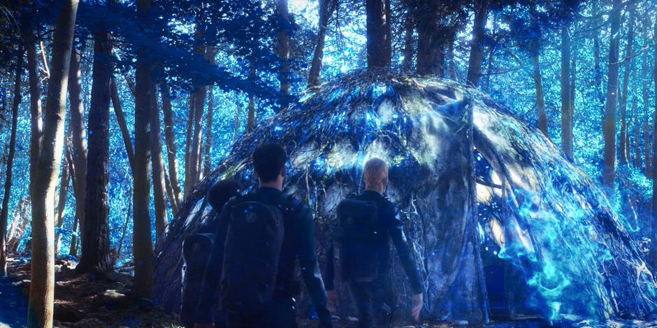 Michael, Ash, and Saru approach a hut sitting alone in the woods.