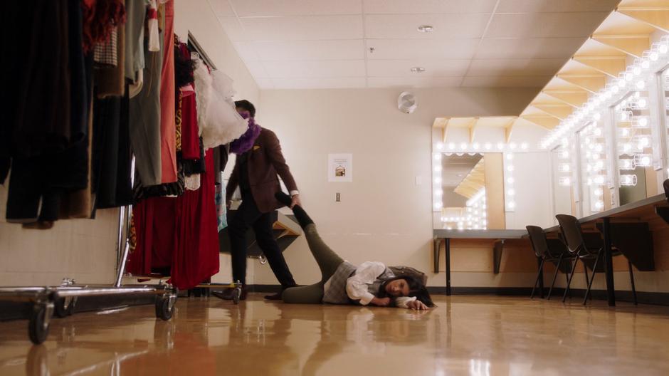 Mr. Morales drags Effie's body out of the dressing room.