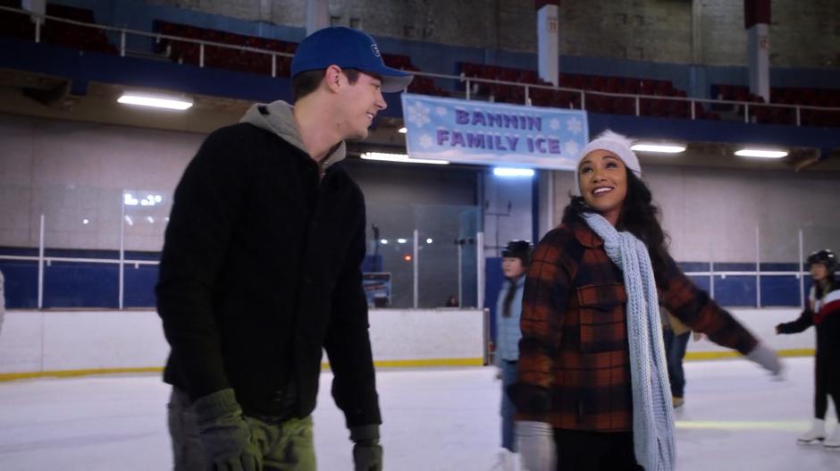 Barry and Iris talk while skating along the ice.