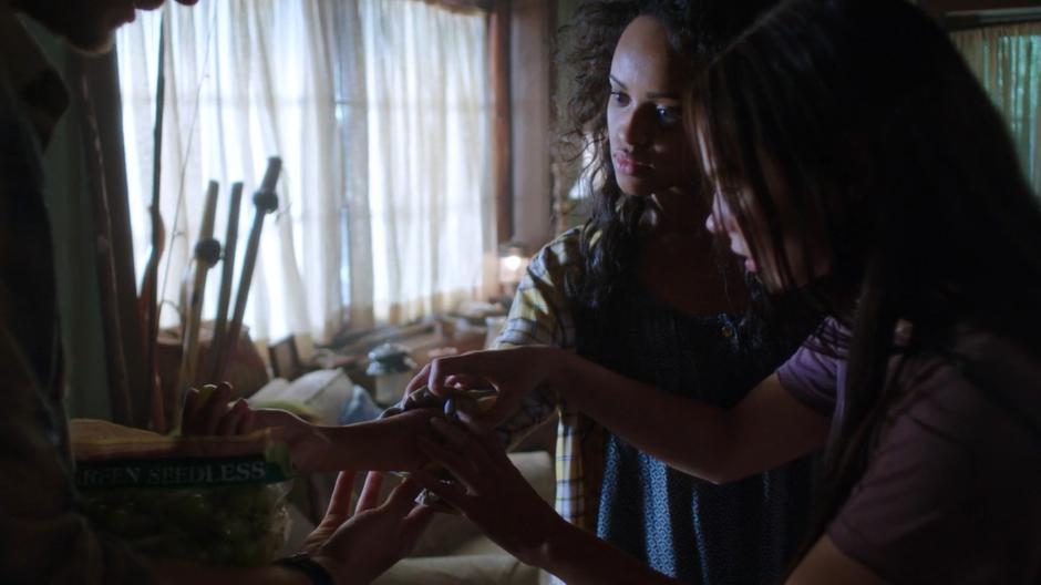 Ben and Ryn examine the peeling skin on Cami's arm.