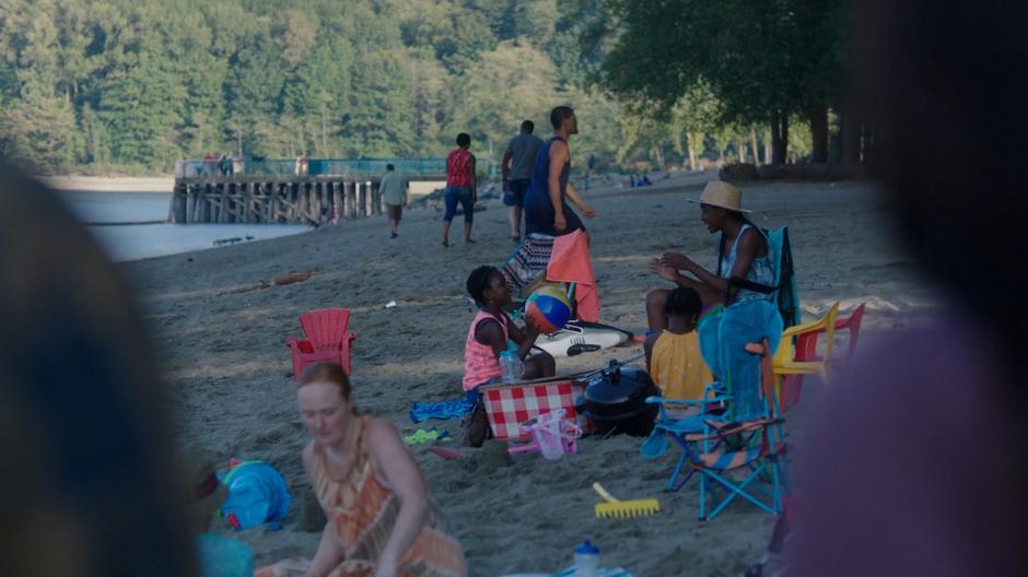 Ben and Ryn look across at the people on the busy beach.