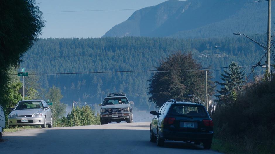 Ben drives up the road looking for Rick Marzdan's house.