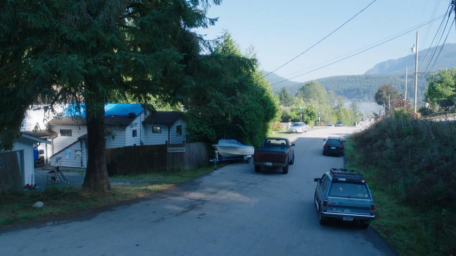 Rick Marzdan drives off down the road while Ben's car sits parked on the side of the street.