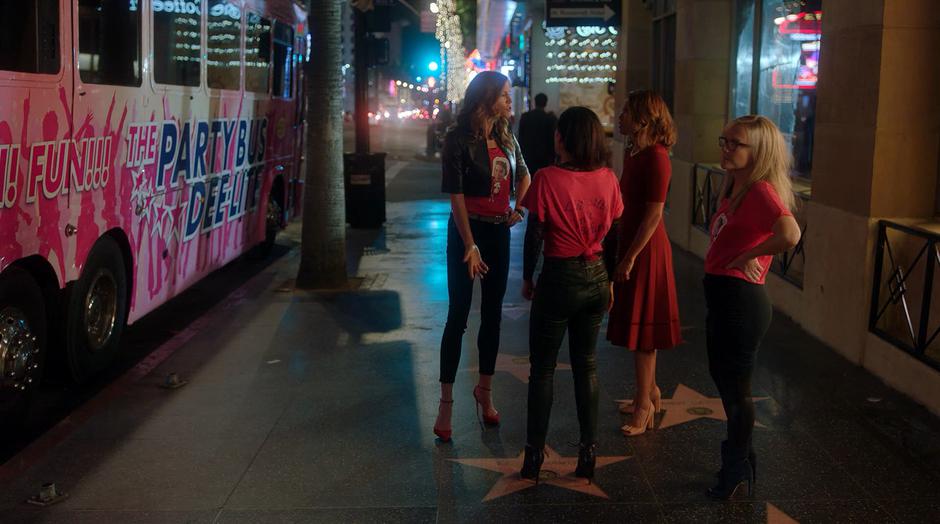Charlotte argues with Maze while Ella and Linda stand around.
