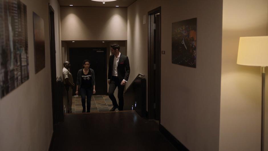 Ella and Lucifer walk up the stairs into Candy's suite.