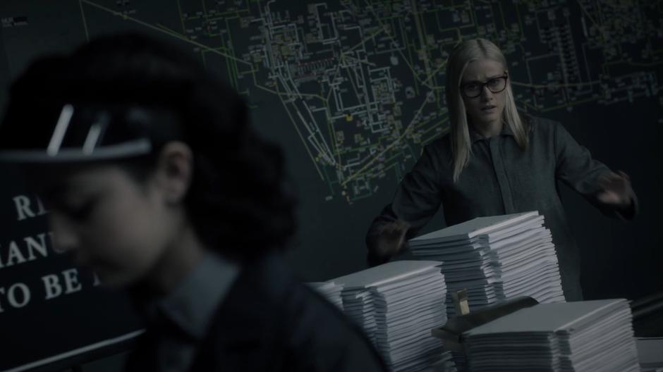 Alice appears in the revisions room and reaches for the manuscripts of her and her friends.