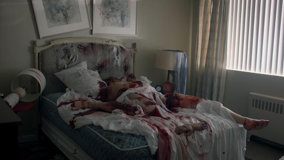 A body that has been ripped to pieces lies in a bloody pile on Enid's bed.