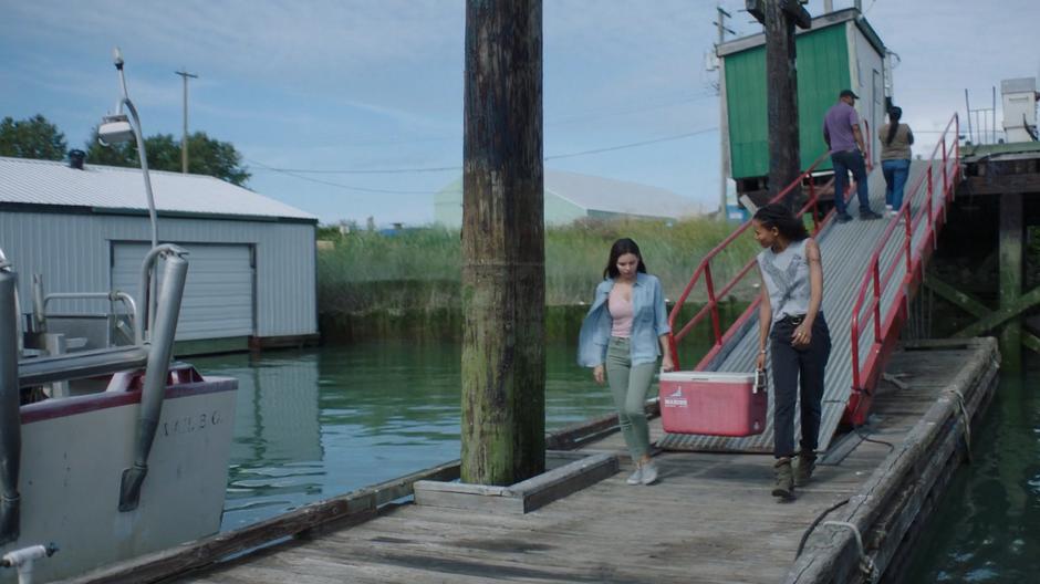 Ryn and Maddie talk while walking down to the dock with a empty cooler.