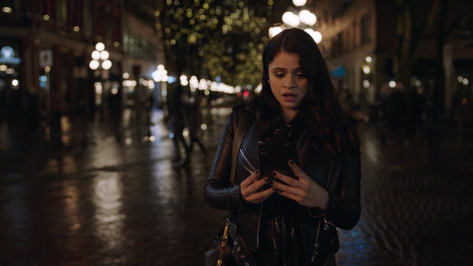 Mel looks at her phone after getting a text from Maggie.