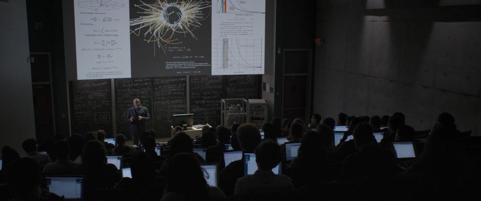 Bill Foster lectures a classroom of students on quantum physics.