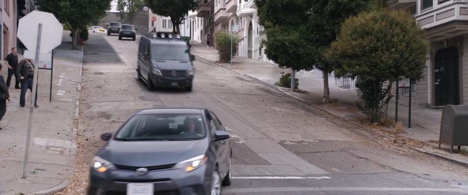 Hope's van races down the hill while two of Sonny Burch's SUVs follow down the hill.