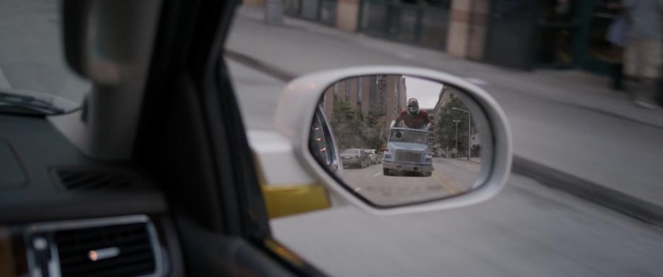 Scott is visible in Sonny Burch's side mirror skating towards him.