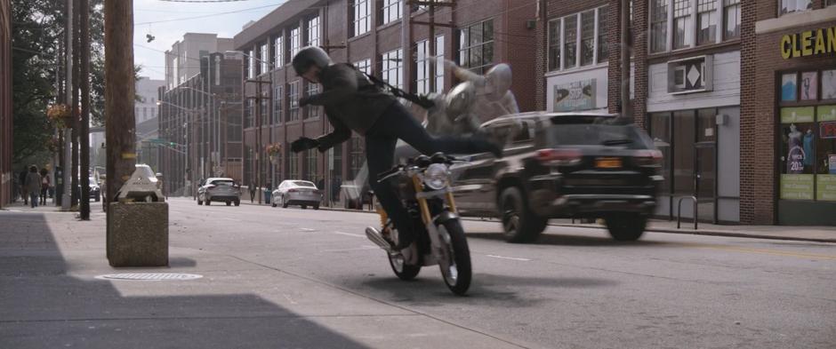 Ghost flies through the air and kicks a goon off their motorcycle.