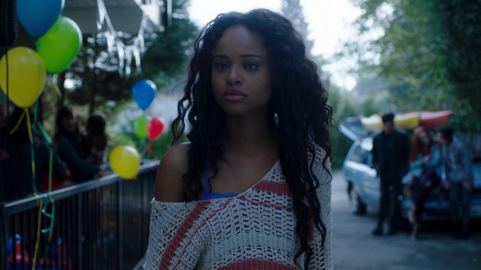 Cami follows Ryn over to the entrance to the apartment building.