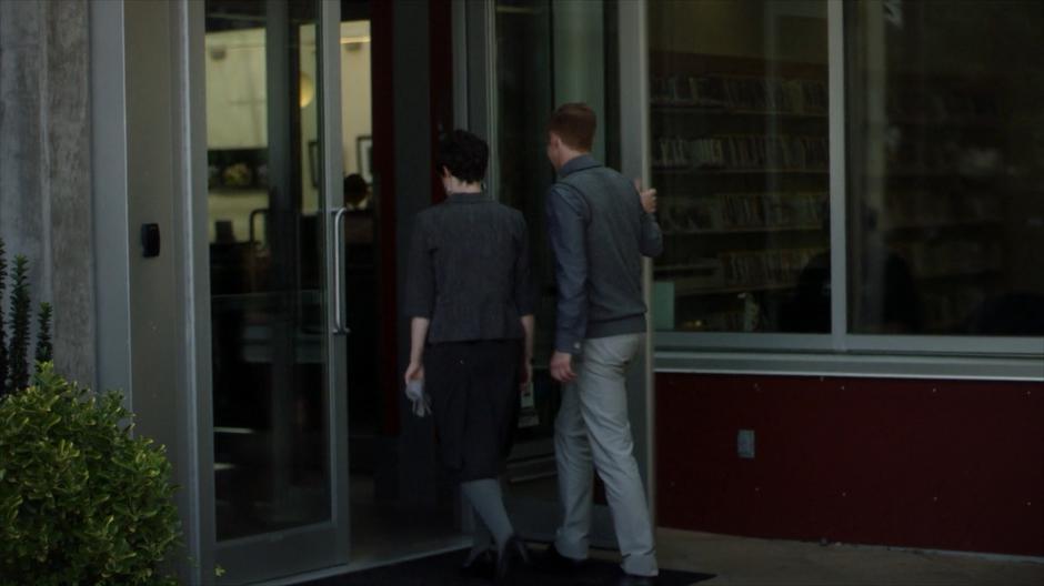 The two librarians who previously talked to Shelia walk into the library.