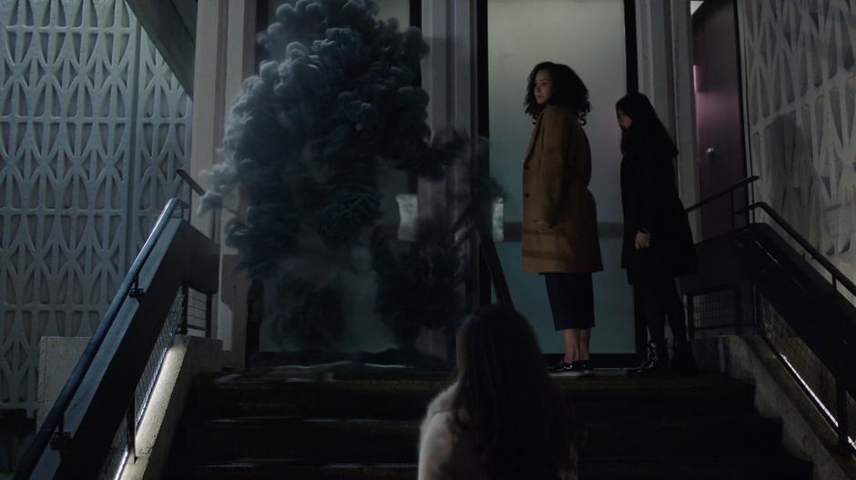 Maggie, Macy, and Mel watch as Parker goes into smoke form to break in to the building.