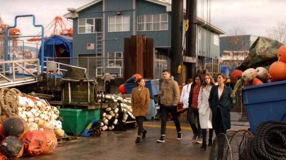 Nora, Barry, Cisco, and Caitlin follow Lyla down to the dock.