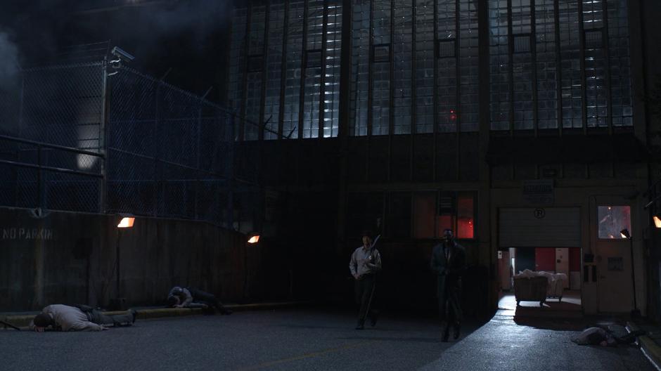 Hat and Manchester walk out of the prison's loading dock.