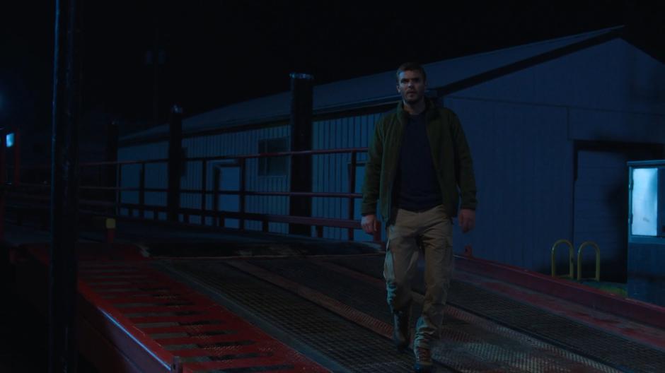 Ben walks onto the pier looking over at Xander's boat.
