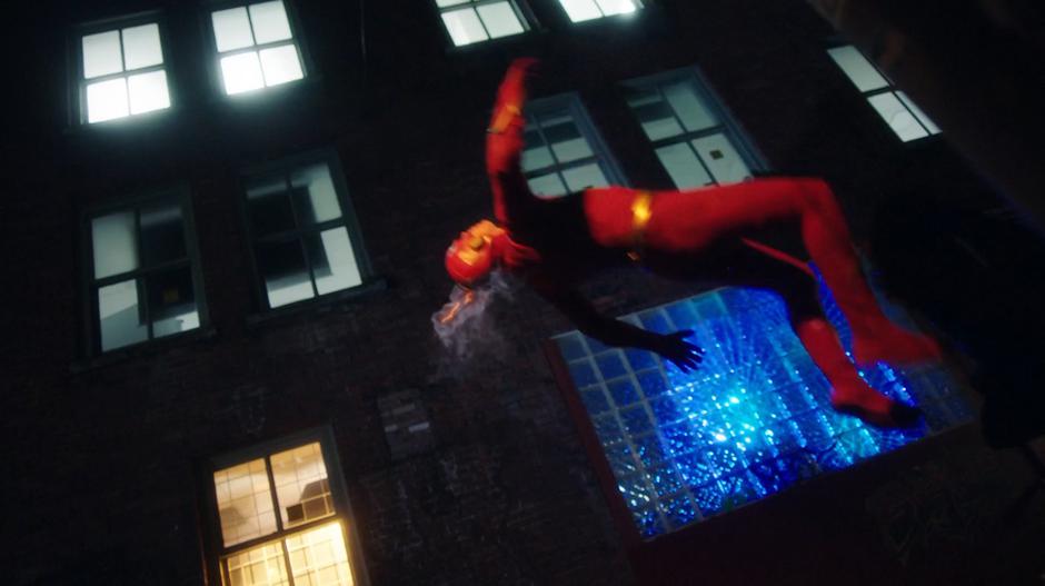 Barry is thrown through the air by Cicada's punch while the dagger is still frozen to the wall of the alley.