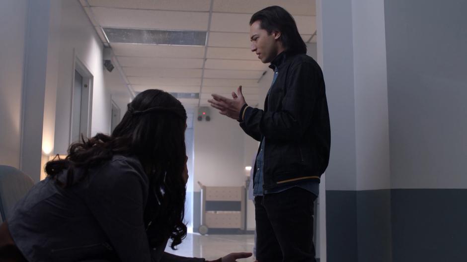 Nia looks up at Brainy as he talks about his feelings.
