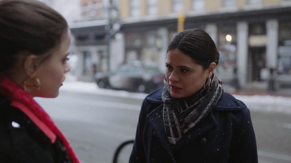 Mel stops and turns to Maggie to theorize about Charity as the snow falls behind them.