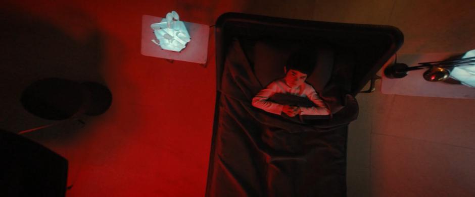 Young Spock lies in bed as the Red Angel appears above him.