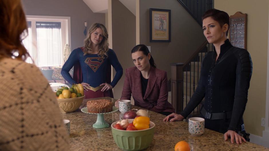 Kara, Lena, and Alex listen as Bitsie Teschmacher tells them she hasn't seen her cousin in weeks.