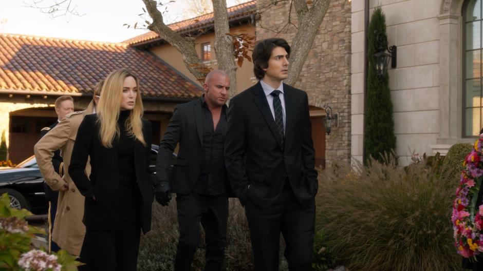 Constantine, Sara, Mick, and Nate walk up to the mansion during the memorial.
