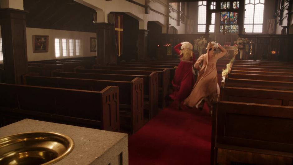 Sara and Mona run through the aisle of the church when they realize they left Zari alone with the fugitive.