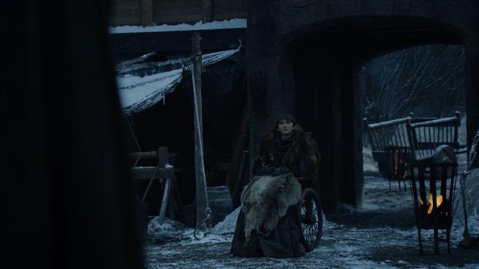 Bran looks across the courtyard at Jaime.